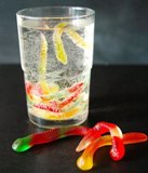 gummy worms in a glass of liquid