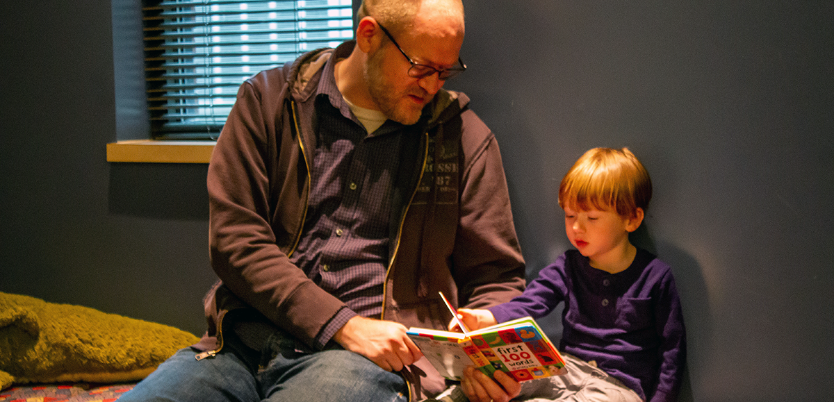 Father and Son reading from a book