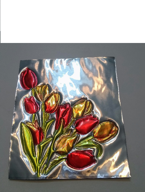 flowers embossed on a tin square