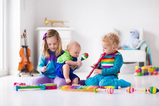 very young children playing with musical instruments