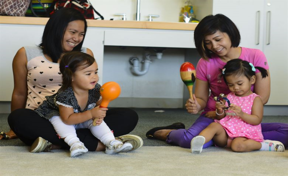 Mothers with babies playing with maracas