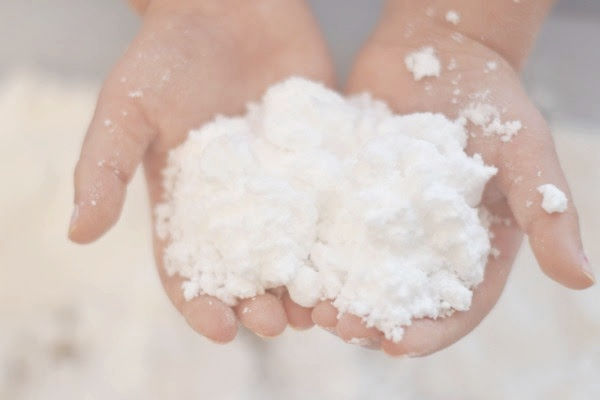 two hands holding artificial snow