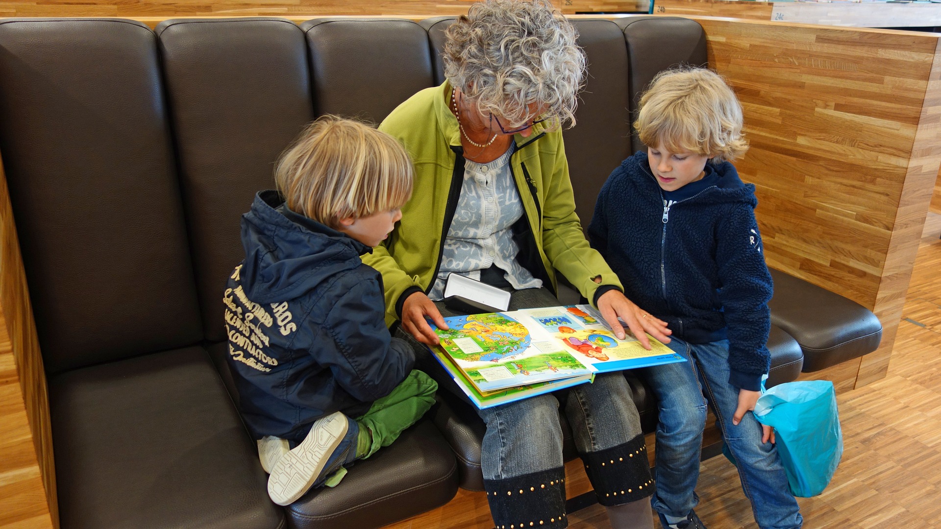 grandmother reading to two children