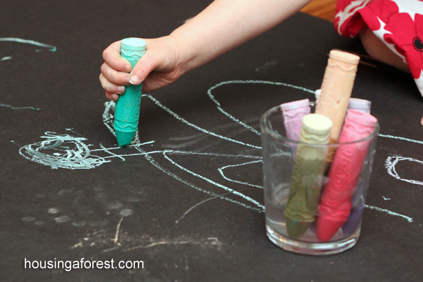 Child drawing with wet chalk
