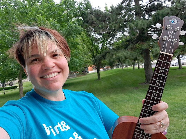 Ms. Dani in the park with her ukulele