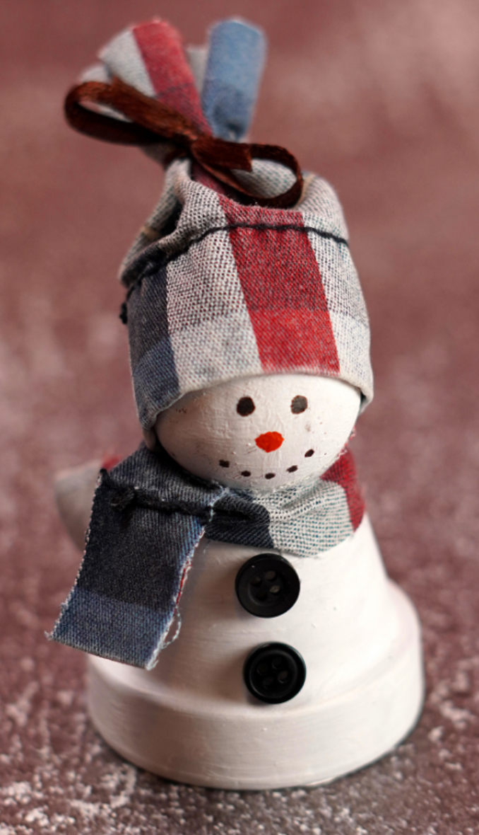 Image of clay pot snowman wearing a scarf and hat
