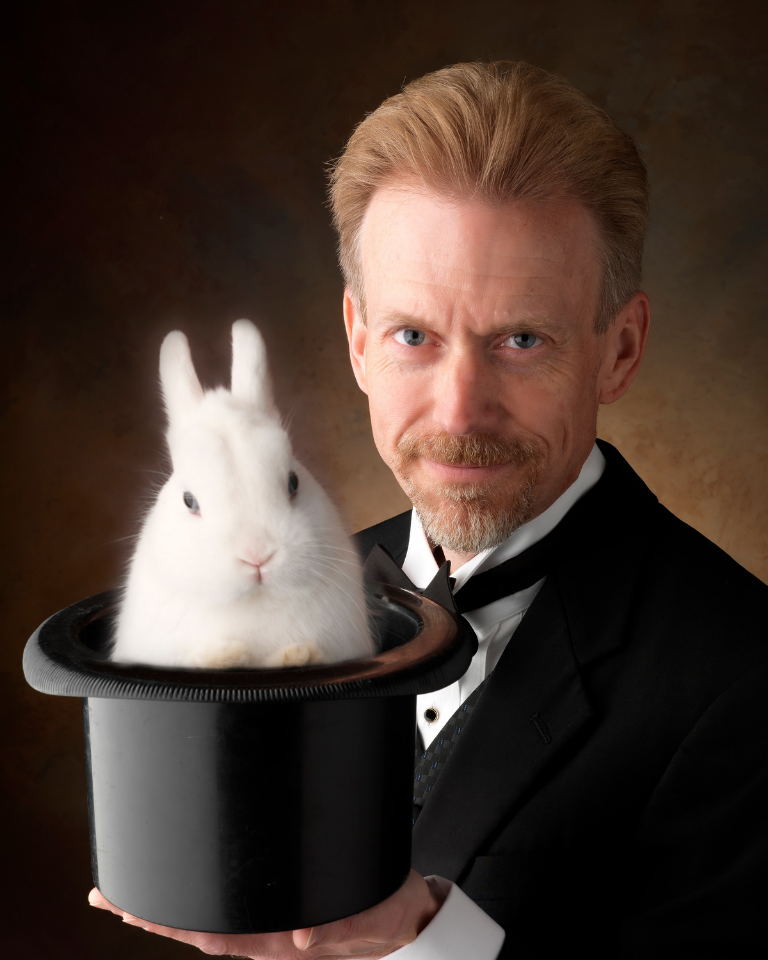 Baffling Bill the Magician with Gus the Bunny (white haired) in a black top hat