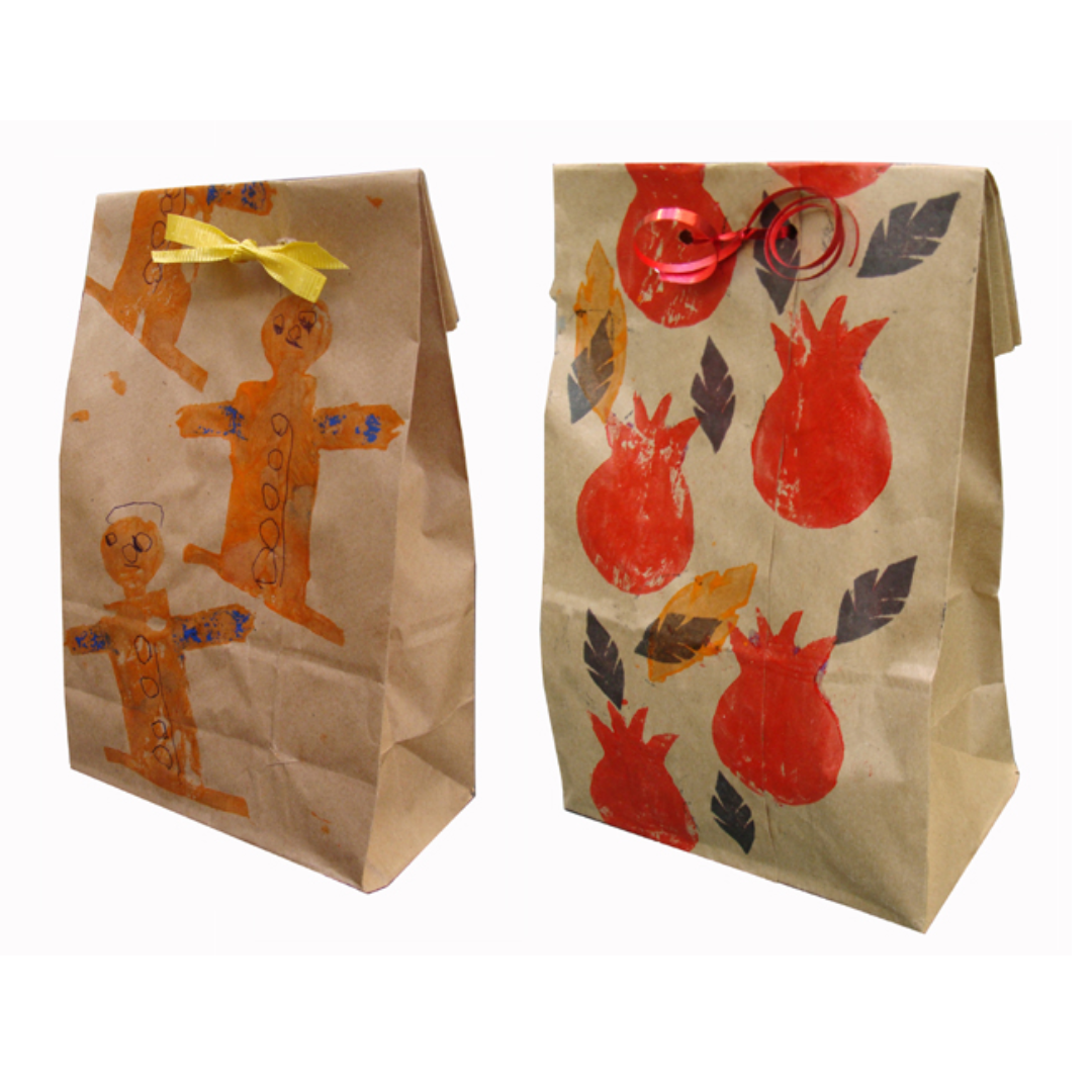 Two Brown Paper Bags Stamped with Gingerbread People and Pineapple and Leaves with Ribbon 