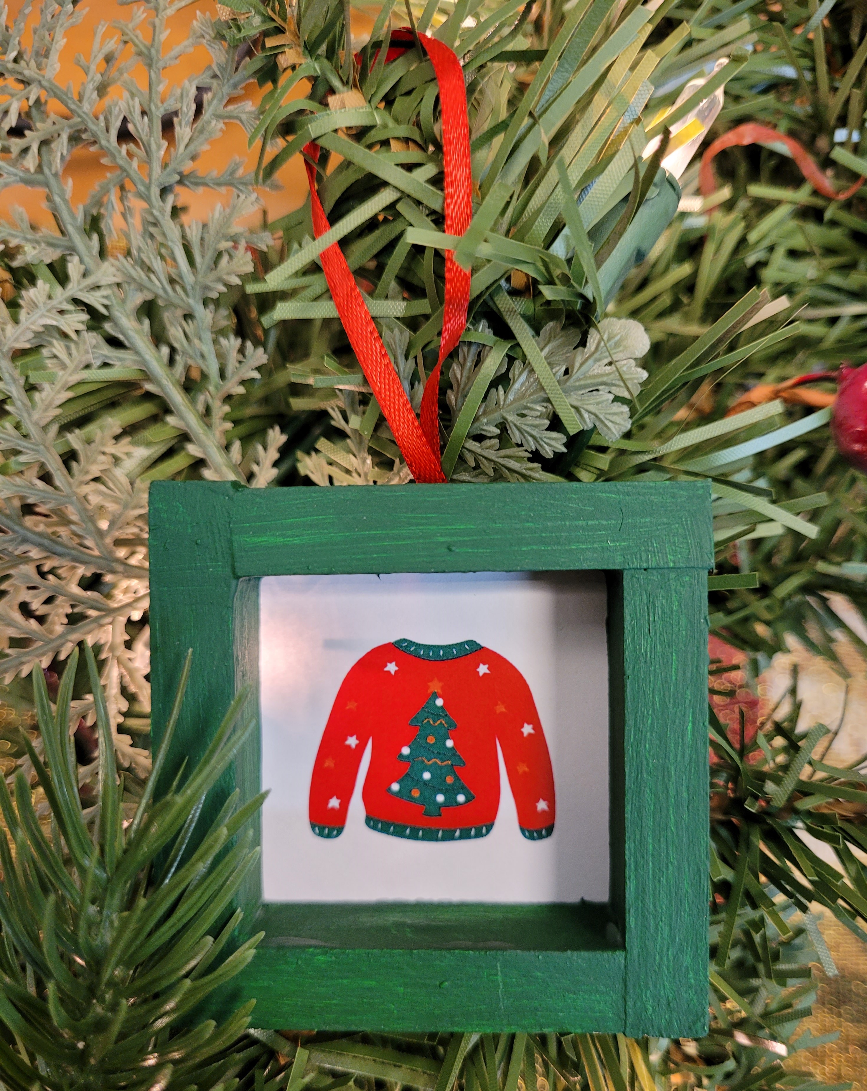 holiday ornament made from Jenga blocks, paper, and ribbon
