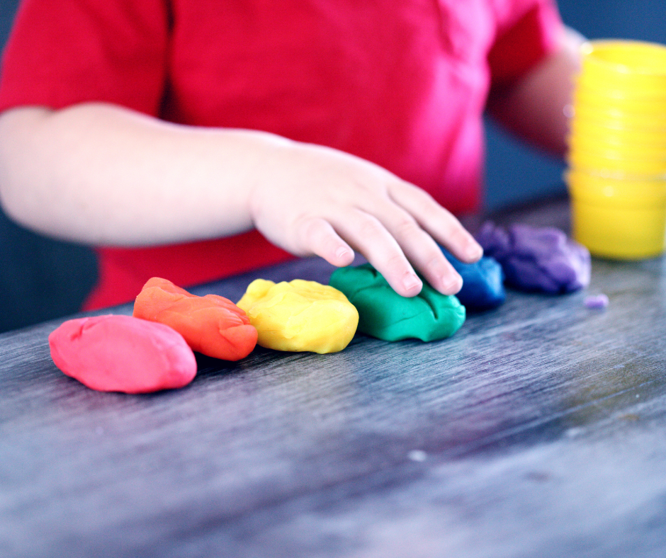 Child playing with colored clay