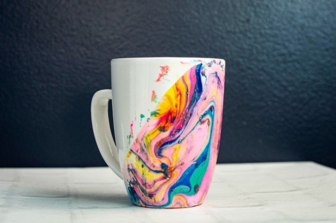 white mug with multicolored marble effect paint on half