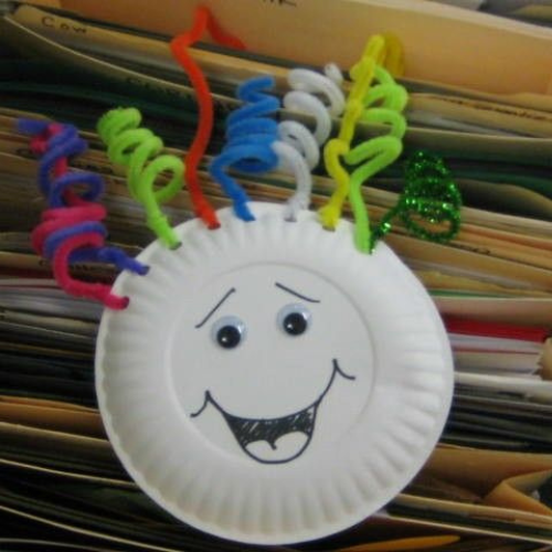 Paper plate with face and colored pipe cleaners for hair