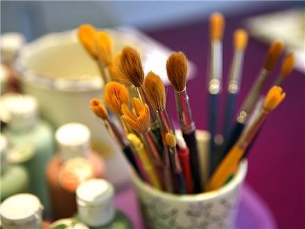 paintbrushes in a cup