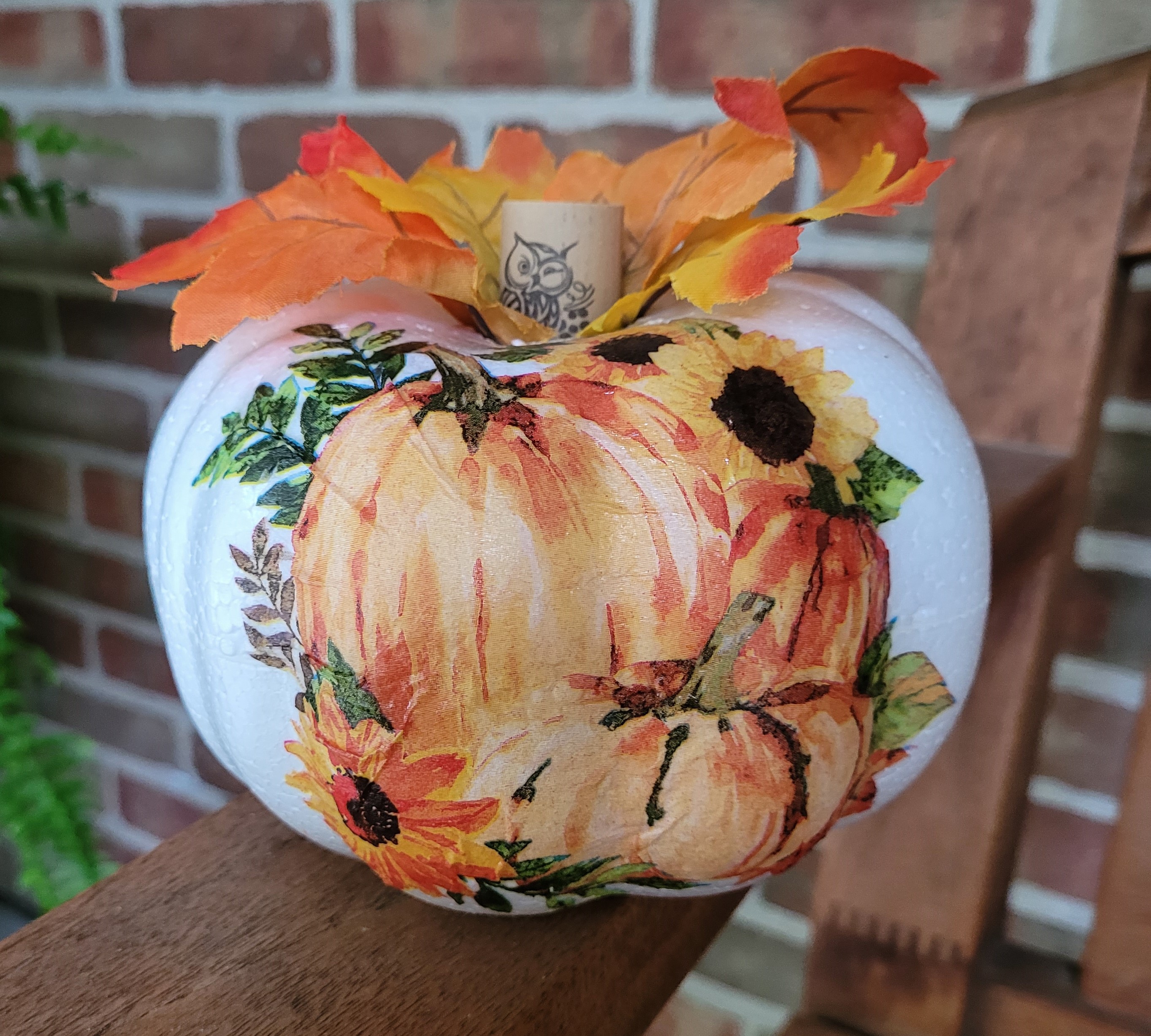 decoupaged white foam pumpkin with fall leaves and wine cork