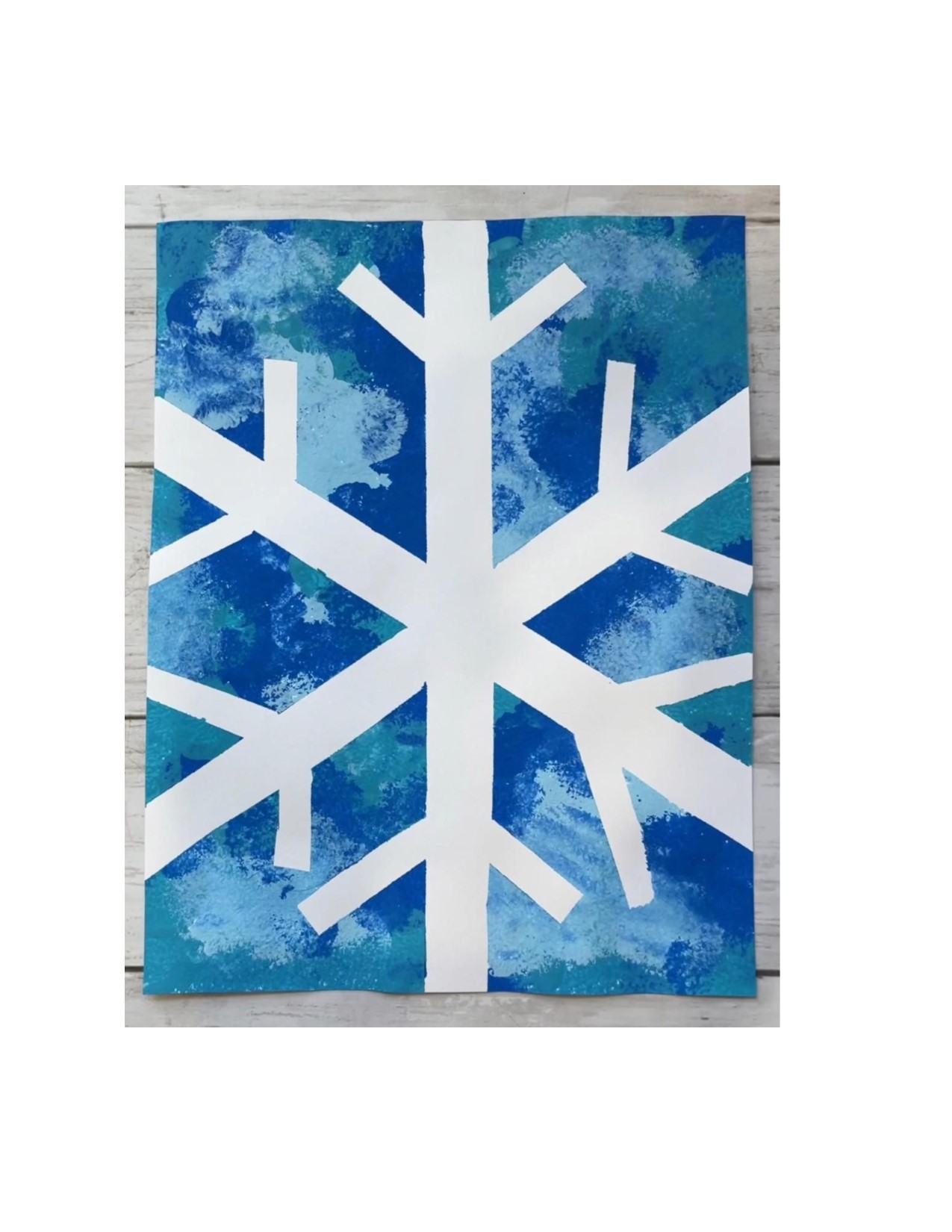 Paint a winter snow scene using masking tape and acrylic paint.
