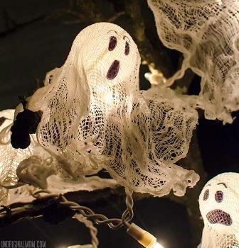 ghost decorations made up of ping pong balls and gauze