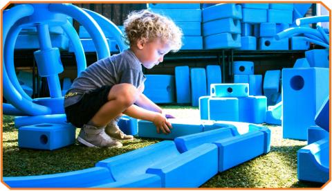 child playing with large blocks