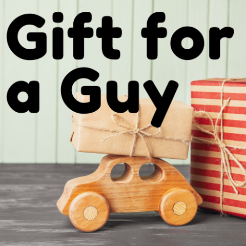 Gifts for a guy and a brown gift on top of a wooden car toy