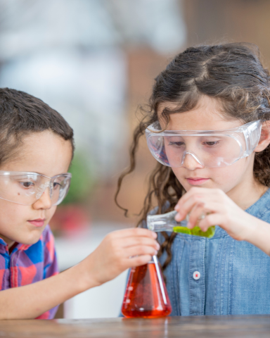 Children boy and girl with a chemistry set