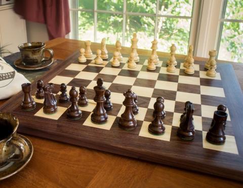 Chess board on table by window