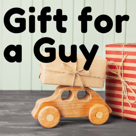 Picture of a wooden car with a package on the roof of the car and the text "Gift for a Guy"