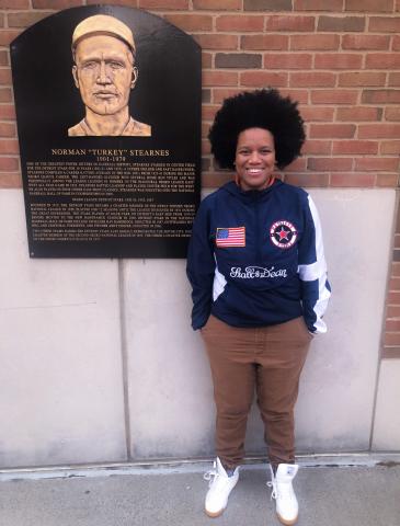 Vanessa Ivy Rose in front of a plaque of Norman "Turkey" Stearnes