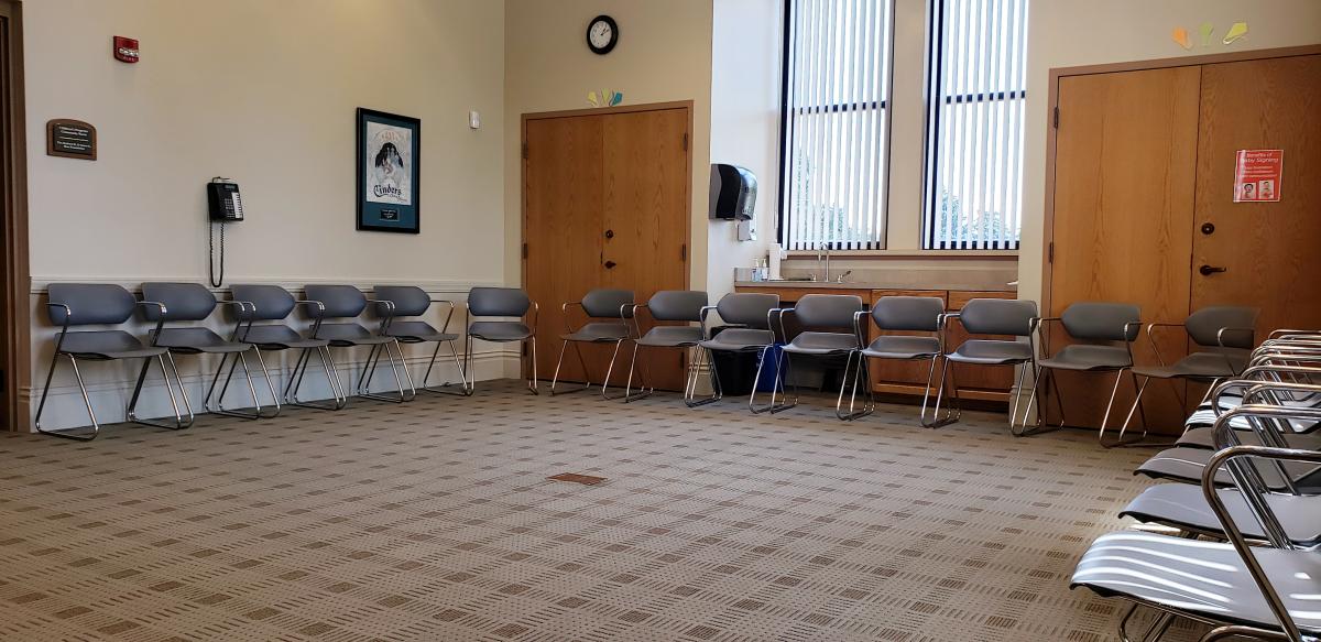 Interior shot of the Sage Community Room with chairs lined up against walls