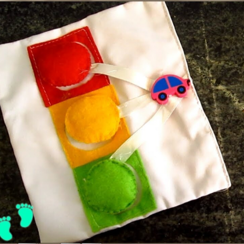 White felt background busy book for babies with a felt car