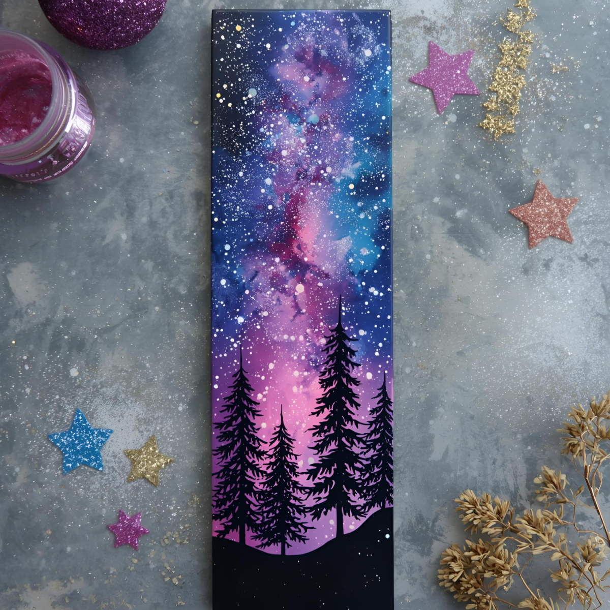 diy bookmark with trees set against a colorful galaxy background